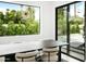 Bright dining room with backyard views, modern chandelier, and access to the outdoor living area with a pool at 4002 N 33Rd Pl, Phoenix, AZ 85018