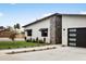 Stunning home exterior highlights modern details, beautiful landscaping, and a sleek garage door, providing a luxurious feel at 4002 N 33Rd Pl, Phoenix, AZ 85018