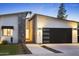 Stylish home featuring stone accents and a black garage door, enhanced by carefully arranged landscaping at 4002 N 33Rd Pl, Phoenix, AZ 85018