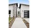 Contemporary home featuring stone accents and a black garage door, highlighted by thoughtful landscaping at 4002 N 33Rd Pl, Phoenix, AZ 85018