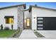 Charming home featuring stone accents, a black garage door and drought-resistant landscaping at 4002 N 33Rd Pl, Phoenix, AZ 85018