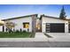 Stylish home showcasing stone accents, a modern garage door, and a well-manicured lawn at 4002 N 33Rd Pl, Phoenix, AZ 85018
