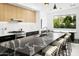 Modern kitchen showcasing stone countertops, stylish cabinets, and a large window with natural light at 4002 N 33Rd Pl, Phoenix, AZ 85018