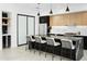 Bright kitchen features a large island with seating, stainless steel appliances, and stylish black and wood cabinetry at 4002 N 33Rd Pl, Phoenix, AZ 85018