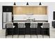 Bright kitchen features a large island with seating, stainless steel appliances, and stylish black and wood cabinetry at 4002 N 33Rd Pl, Phoenix, AZ 85018