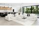 Expansive living room with sofas, a backyard view, and an open connection to the modern kitchen at 4002 N 33Rd Pl, Phoenix, AZ 85018