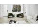 Bright living room with stylish chairs, modern decor, and large windows providing natural light at 4002 N 33Rd Pl, Phoenix, AZ 85018
