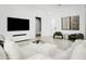 Bright living room with comfortable seating, modern fireplace, and large flat screen TV at 4002 N 33Rd Pl, Phoenix, AZ 85018