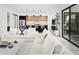 Open-concept living room with comfortable sofas, modern kitchen view, and lots of natural light at 4002 N 33Rd Pl, Phoenix, AZ 85018