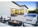 Cozy patio with a fire pit, lounge seating, and a luxurious pool under a vibrant evening sky at 4002 N 33Rd Pl, Phoenix, AZ 85018