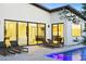 Elegant patio with lounge chairs offers a relaxing view of the modern interior through sliding glass doors at 4002 N 33Rd Pl, Phoenix, AZ 85018