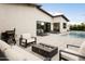 Inviting outdoor patio with a modern fire pit, grill, and lounge chairs by the sparkling pool at 4002 N 33Rd Pl, Phoenix, AZ 85018