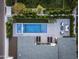Aerial view of a backyard oasis with a modern pool, patio seating, and lush landscaping, perfect for outdoor entertaining at 4002 N 33Rd Pl, Phoenix, AZ 85018