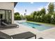 Inviting pool area with comfortable lounge chairs, a spa, and manicured landscaping for relaxation at 4002 N 33Rd Pl, Phoenix, AZ 85018