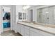 Bright bathroom with dual sinks, modern fixtures, and a glass shower enclosure at 40990 W Agave Rd, Maricopa, AZ 85138