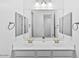 Elegant bathroom featuring dual sinks, a large mirror, and modern fixtures at 40990 W Agave Rd, Maricopa, AZ 85138