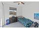 Bright bedroom with a large window, dresser, and playful decor at 40990 W Agave Rd, Maricopa, AZ 85138