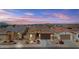 Charming single-story home boasting a well-manicured lawn, stone accents, and a spacious two-car garage at 40990 W Agave Rd, Maricopa, AZ 85138