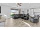 Open concept living room featuring tile floors, recessed lighting, and a large sectional sofa at 40990 W Agave Rd, Maricopa, AZ 85138