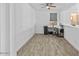 Functional home office space with wood-look tile flooring and abundant natural light at 40990 W Agave Rd, Maricopa, AZ 85138