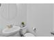 Classic powder room featuring a pedestal sink, toilet, and decorative accents at 40990 W Agave Rd, Maricopa, AZ 85138