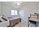 Bright bedroom with a neutral palette, closet, and desk, offering a cozy and functional space at 4445 W Oraibi Dr, Glendale, AZ 85308