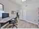 Bright bedroom features a vaulted ceiling, a ceiling fan, a modern desk and an open doorway at 4445 W Oraibi Dr, Glendale, AZ 85308