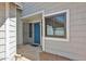 Attractive front entrance featuring a blue door, sidelight window, and neutral siding at 4445 W Oraibi Dr, Glendale, AZ 85308