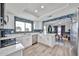 Beautiful kitchen featuring white cabinets, quartz countertops, and stainless steel appliances at 4445 W Oraibi Dr, Glendale, AZ 85308