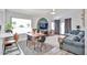 Bright living room featuring modern furniture, stylish rug, ceiling fan, and glass sliding doors for outdoor access at 4445 W Oraibi Dr, Glendale, AZ 85308