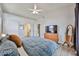 Large main bedroom with a ceiling fan, a dresser with a TV, and ensuite access at 4445 W Oraibi Dr, Glendale, AZ 85308