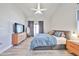 Spacious main bedroom with vaulted ceilings, a ceiling fan, dresser, and access to a private outdoor patio at 4445 W Oraibi Dr, Glendale, AZ 85308