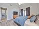 Bright main bedroom with vaulted ceiling, fan, access to outdoor living spaces and contemporary decor at 4445 W Oraibi Dr, Glendale, AZ 85308