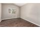 Cozy bedroom showcasing hardwood floors, natural light, and neutral decor at 44859 W Sage Brush Dr, Maricopa, AZ 85139