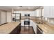 Modern kitchen boasting stainless steel appliances, granite counters, and white cabinetry at 44859 W Sage Brush Dr, Maricopa, AZ 85139
