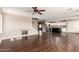 Open-concept living space with hardwood floors connecting to the stairs, kitchen, and other living areas at 44859 W Sage Brush Dr, Maricopa, AZ 85139