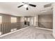 Open loft space featuring a ceiling fan, natural lighting, and neutral carpeting at 44859 W Sage Brush Dr, Maricopa, AZ 85139