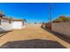 Spacious dirt back yard with block fence and mature trees in the background at 4611 N 79Th Dr, Phoenix, AZ 85033