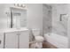 Updated bathroom featuring modern vanity, and bathtub with gray tile surround at 4611 N 79Th Dr, Phoenix, AZ 85033