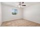 Well-lit bedroom featuring a ceiling fan and window providing natural light at 4611 N 79Th Dr, Phoenix, AZ 85033