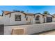 Attractive single-story home with a decorative brick wall and a black garage door at 4611 N 79Th Dr, Phoenix, AZ 85033