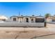Charming single-story home featuring a stylish black garage door and an eye-catching arched entryway at 4611 N 79Th Dr, Phoenix, AZ 85033