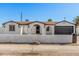 Charming single-story home featuring a stylish black garage door and an eye-catching arched entryway at 4611 N 79Th Dr, Phoenix, AZ 85033