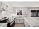 Bright kitchen featuring stainless steel appliances, white cabinets, and granite countertops at 4611 N 79Th Dr, Phoenix, AZ 85033