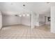 Bright living room featuring tile floors, a ceiling fan, and an open layout to the dining area at 4611 N 79Th Dr, Phoenix, AZ 85033
