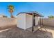 View of outdoor storage shed with concrete block wall and a palm tree in the background at 4611 N 79Th Dr, Phoenix, AZ 85033