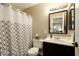 Well-lit bathroom featuring a modern vanity, framed mirror, and patterned shower curtain at 501 W Tonopah Dr # 7, Phoenix, AZ 85027