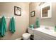 Charming bathroom boasts stylish decor, vanity, and coordinated turquoise accessories at 501 W Tonopah Dr # 7, Phoenix, AZ 85027