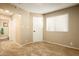 Carpeted bedroom with a bright window and ample natural light at 501 W Tonopah Dr # 7, Phoenix, AZ 85027