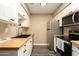Well-lit kitchen featuring sleek stainless steel appliances and butcher block countertops at 501 W Tonopah Dr # 7, Phoenix, AZ 85027
